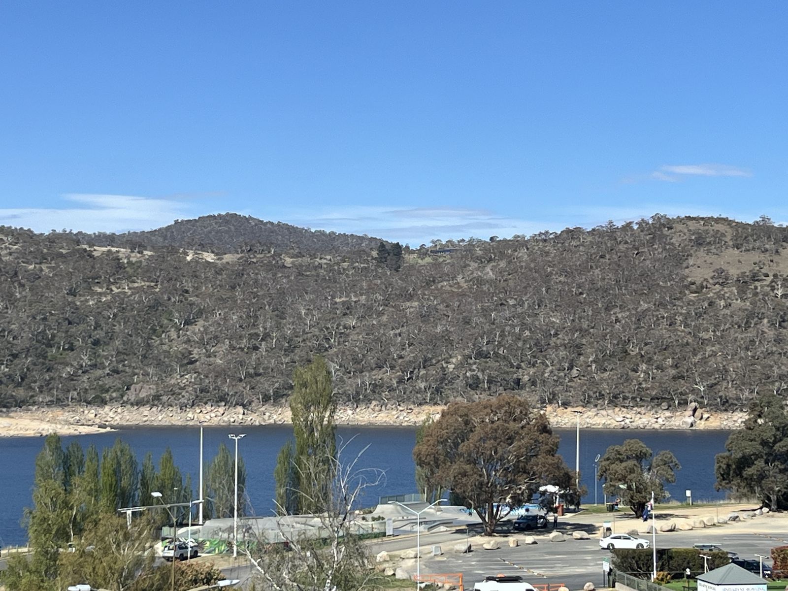 Lake Jindabyne and the hills seen from the balcony, with the skate park below