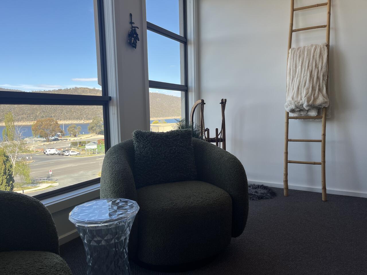 Bouclé armchair by the corner window