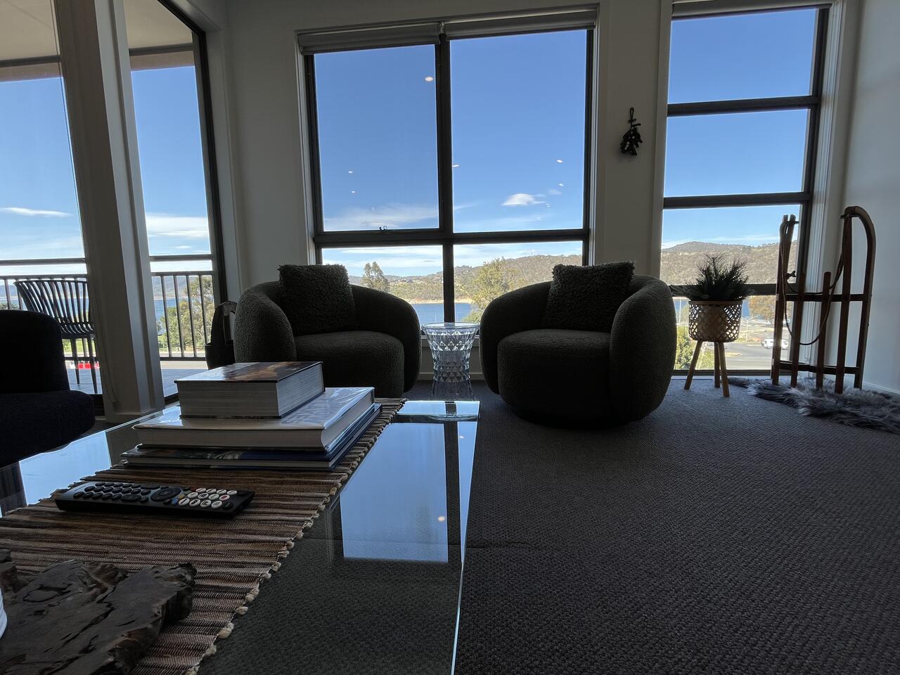 Living room with floor-to-ceiling windows over Lake Jindabyne