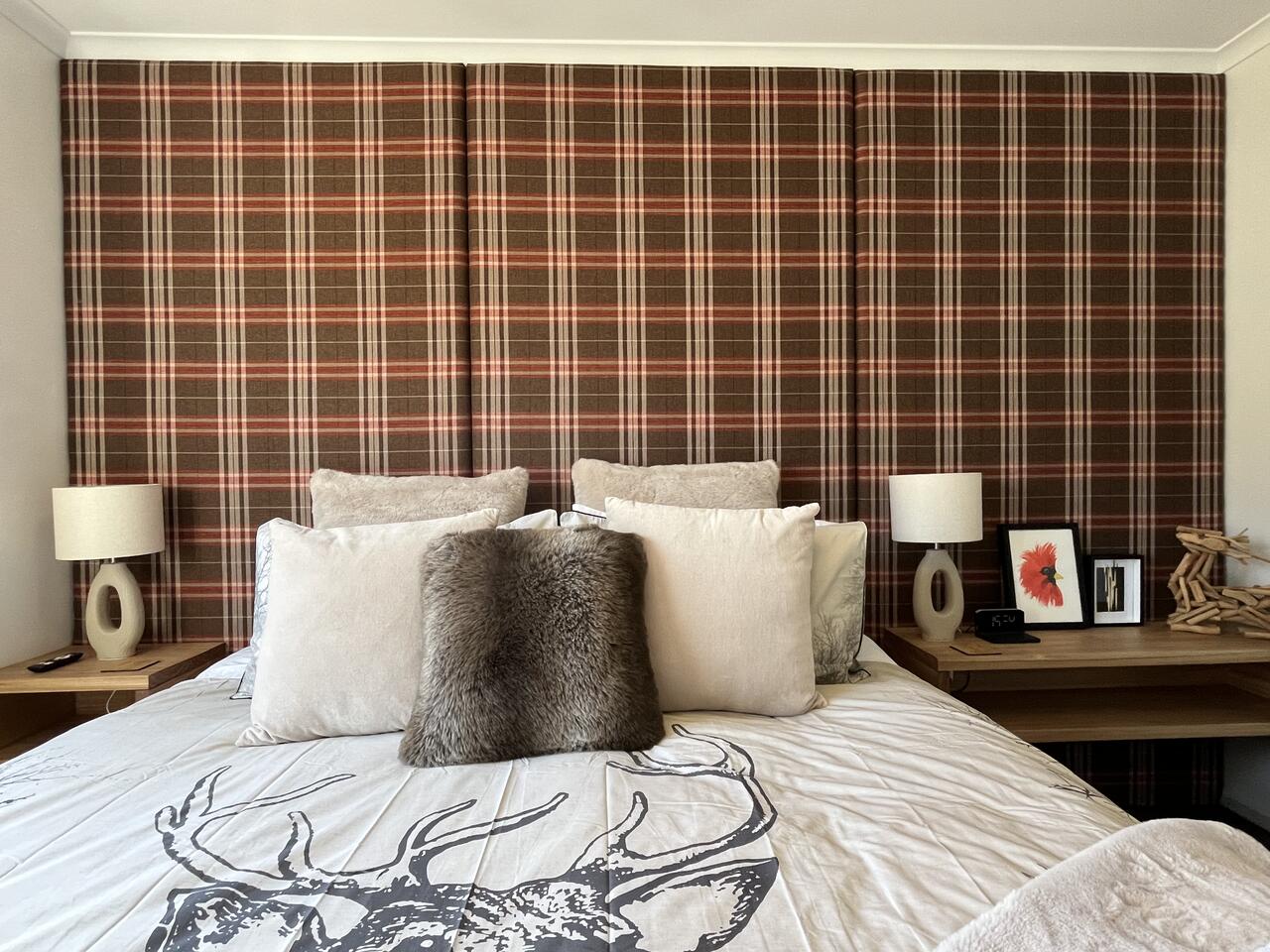 Master bedroom with tartan feature wall and lake view