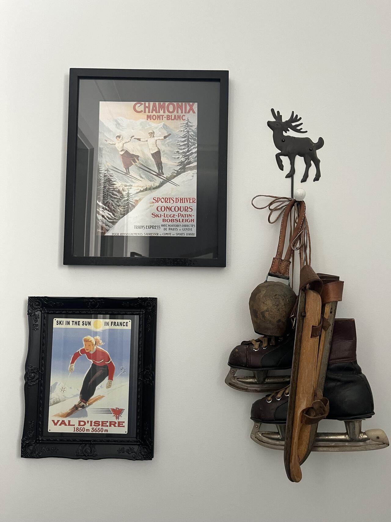 Framed vintage ski posters and antique ski boots