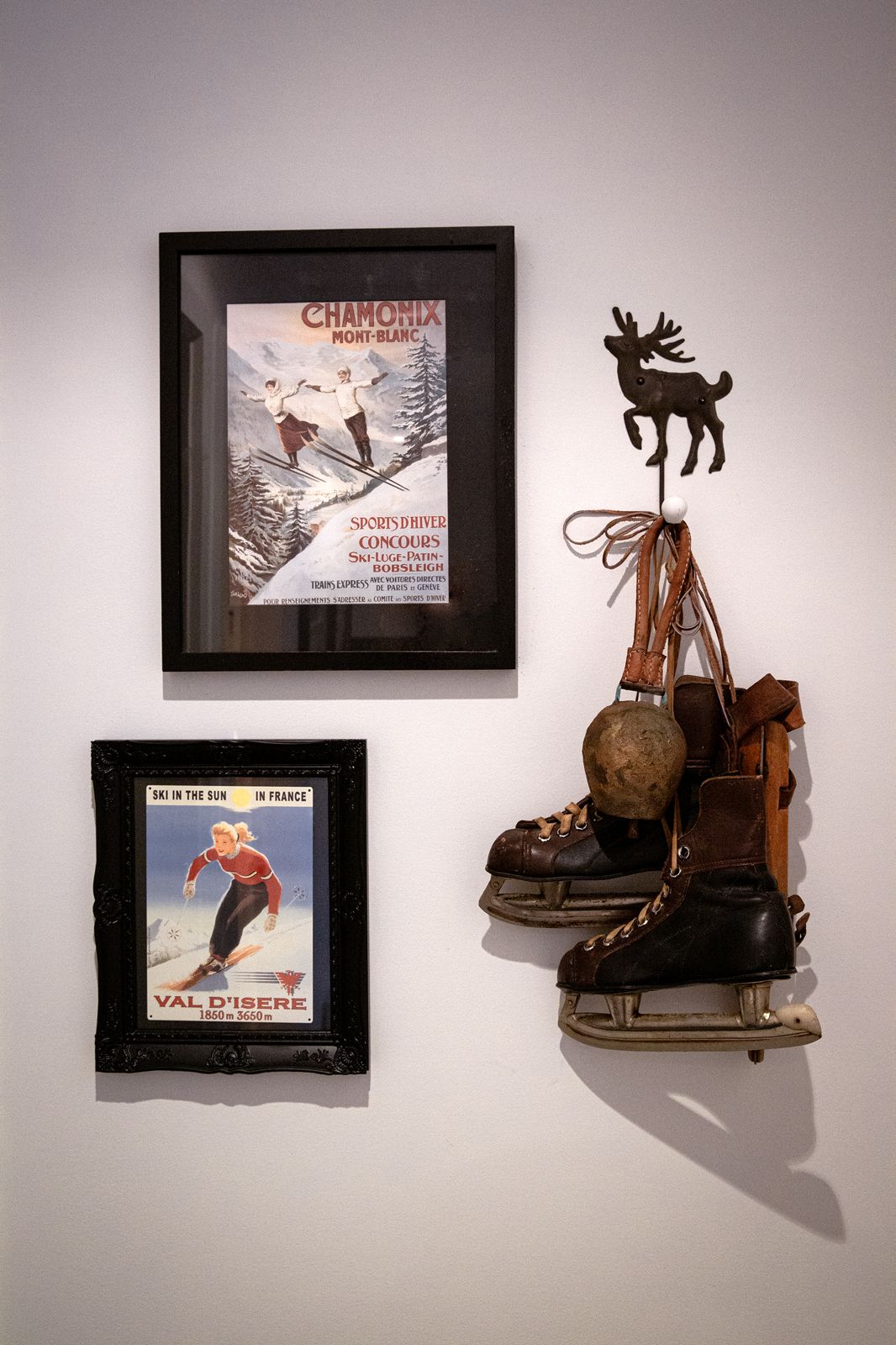 Vintage Chamonix and Val d'Isère posters with old ice skates and a cowbell