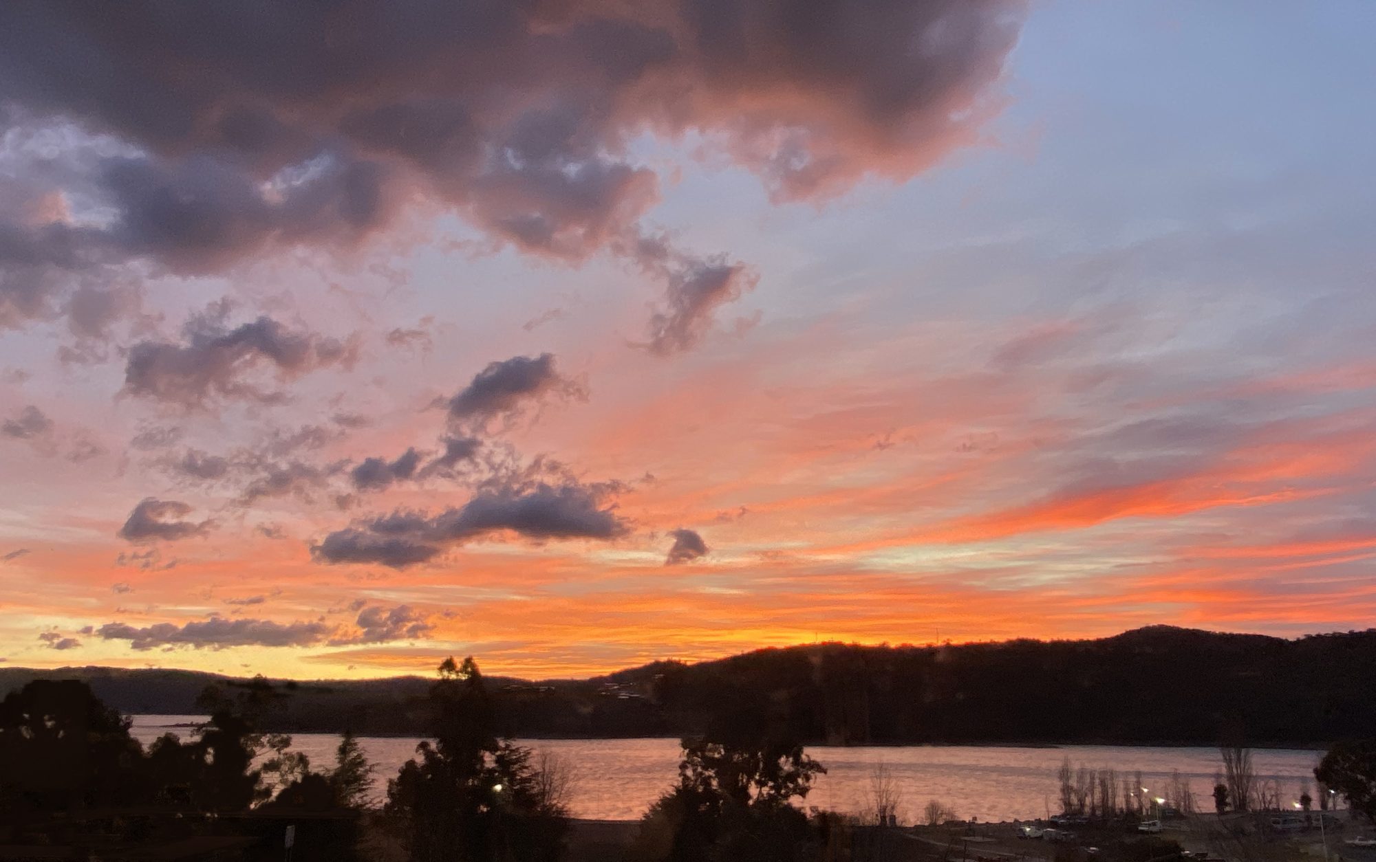 Orange and pink sunset over Lake Jindabyne, seen from the apartment